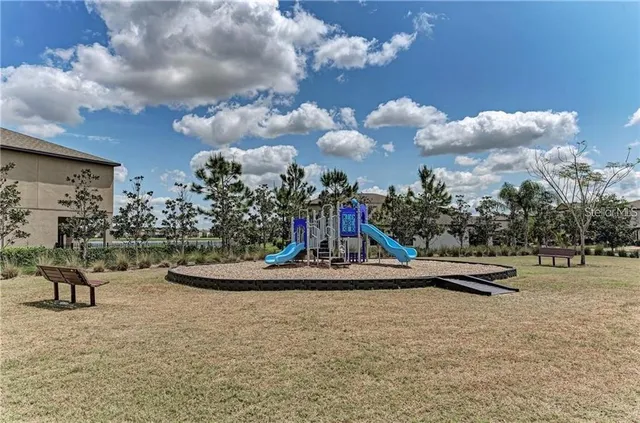 a swimming pool with outdoor seating and garden