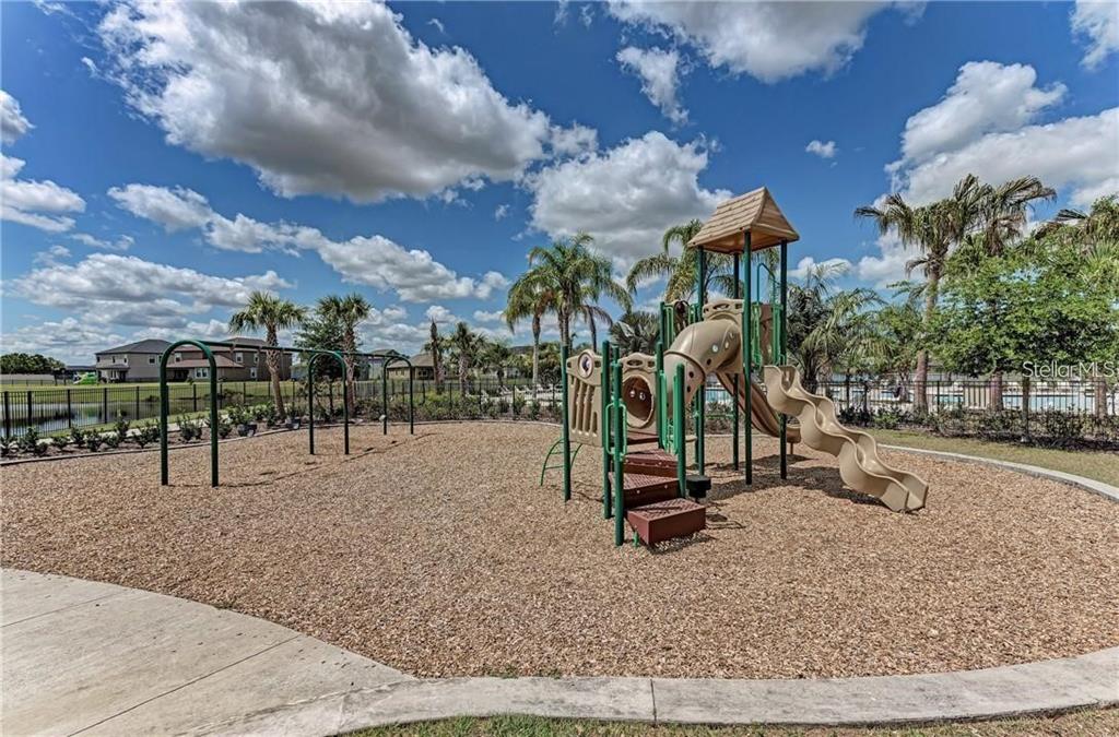10267 Newminster Loop Ruskin, FL 33573 - Photo 36 of 38 a park with lots of swings slides