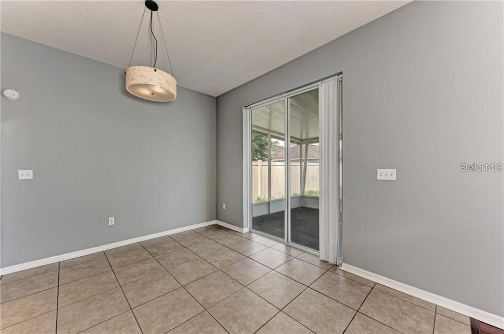 10267 Newminster Loop Ruskin, FL 33573 - Photo 5 of 38 a view of an empty room with window and chandelier fan