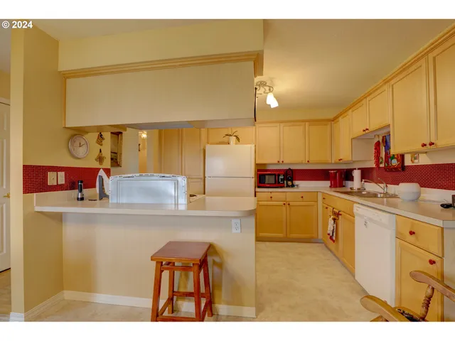 a kitchen with cabinets and white appliances