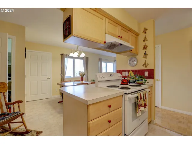 a kitchen that has a sink and a stove in it