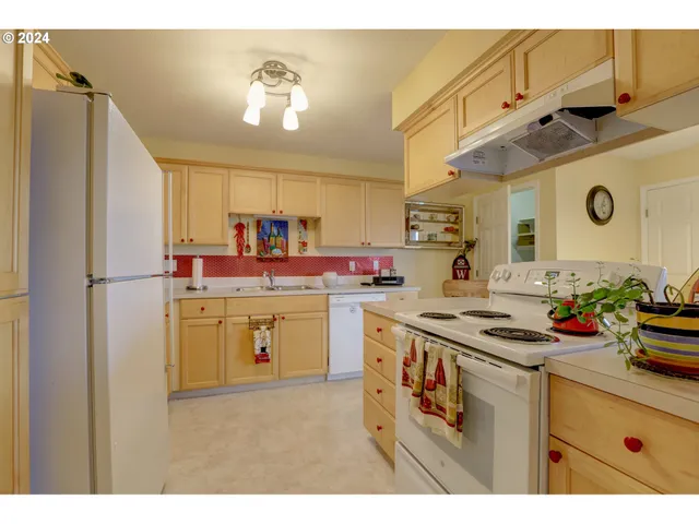 a kitchen that has a sink and a stove in it