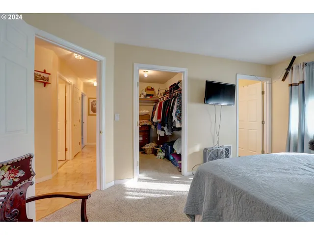 a bedroom with a bed and a view of living room