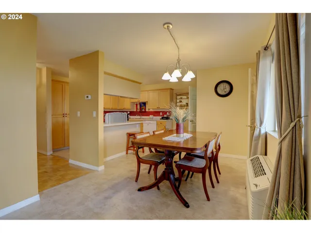 a dining room with a wooden table and chairs