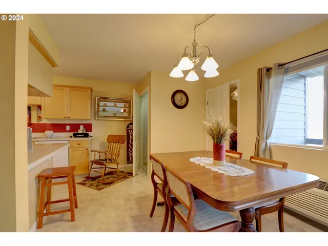 a view of a dining room with furniture and chandelier