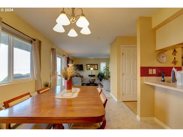 a view of a dining room with furniture and a chandelier
