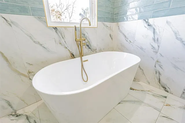 a bathroom with a bathtub and window