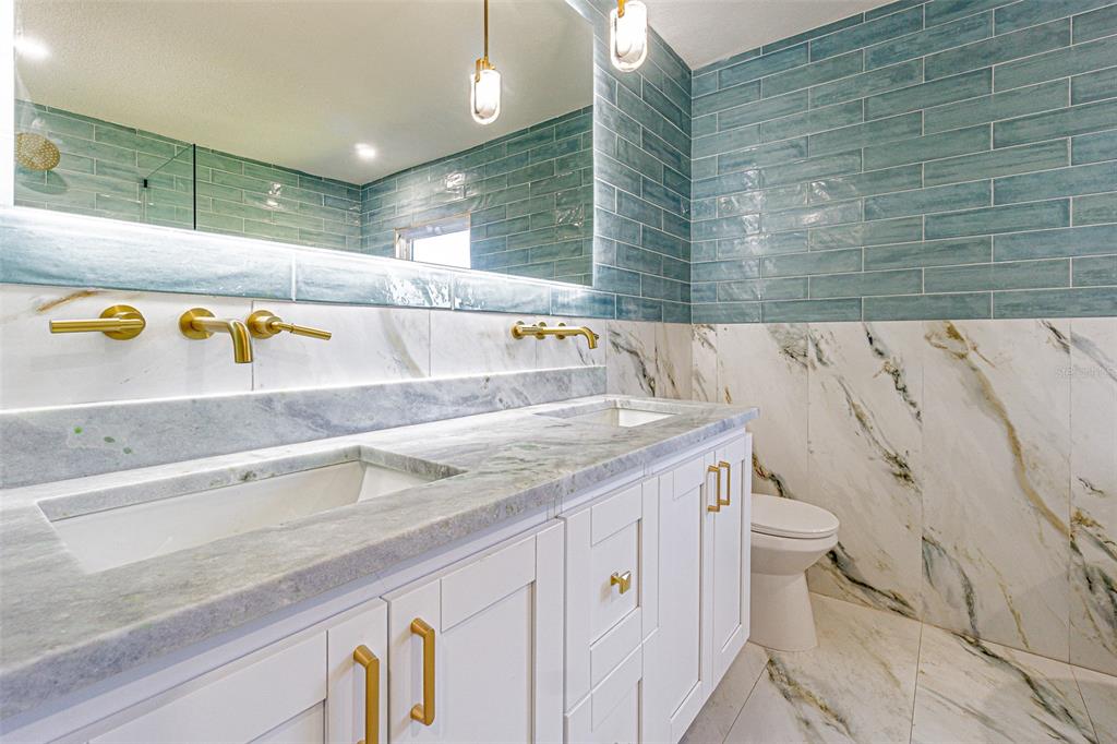 6370 Conniewood Square New Port Richey, FL 34653 - Photo 12 of 27 a bathroom with a granite countertop bathtub and sink