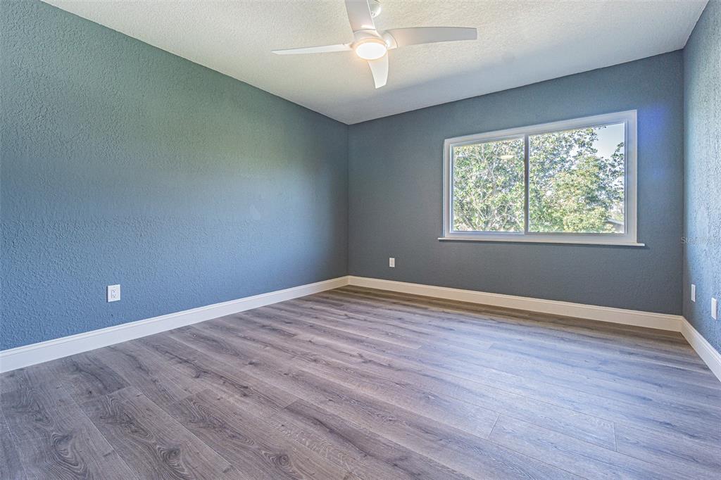 6370 Conniewood Square New Port Richey, FL 34653 - Photo 14 of 27 an empty room with wooden floor and windows