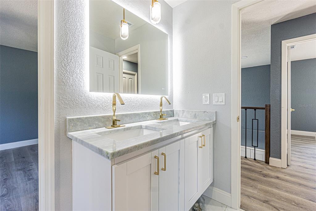 6370 Conniewood Square New Port Richey, FL 34653 - Photo 15 of 27 a bathroom with a granite countertop sink and a mirror