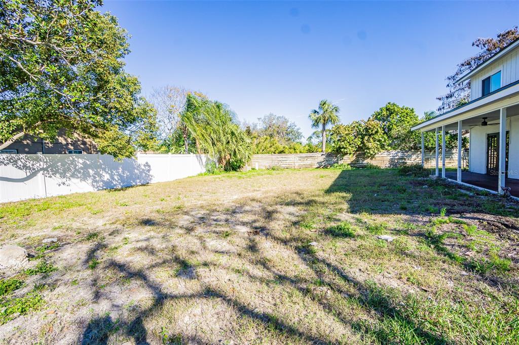 6370 Conniewood Square New Port Richey, FL 34653 - Photo 20 of 27 a view of a yard with plants and trees