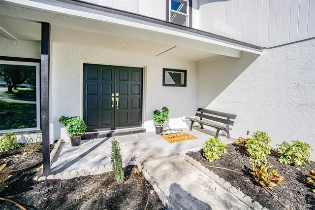 a view of a patio with table and chairs and potted plants