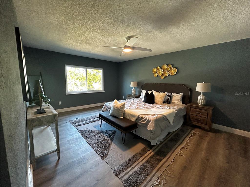 6370 Conniewood Square New Port Richey, FL 34653 - Photo 24 of 27 a bedroom with a bed and a flat screen tv