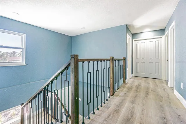 a view of a hallway with wooden floor and entryway