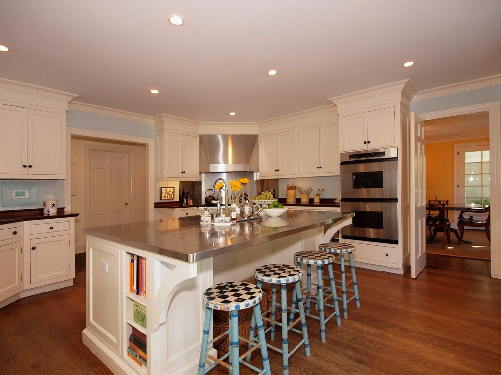 230 Rosebrook Road New Canaan, CT 06840 - Photo 14 of 25 a kitchen with stainless steel appliances granite countertop a stove top oven a sink a refrigerator with white cabinets and wooden floor