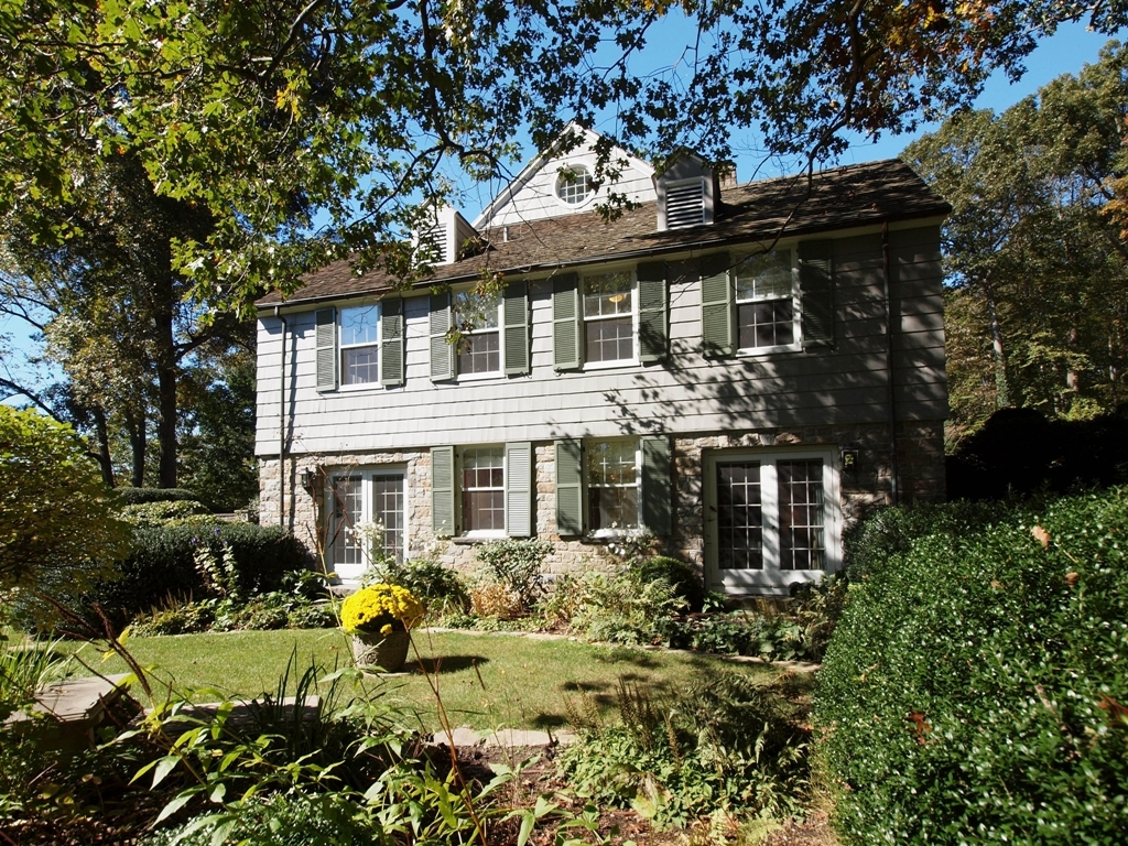 230 Rosebrook Road New Canaan, CT 06840 - Photo 5 of 25 a front view of a house with a garden and pathway