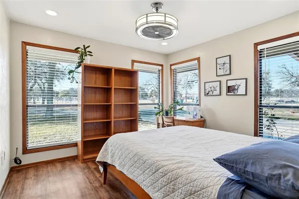 a bedroom with a large bed and a window