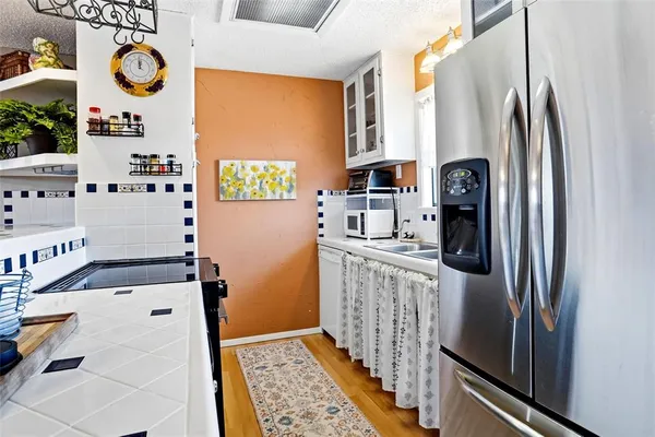a kitchen with stainless steel appliances a refrigerator and a stove