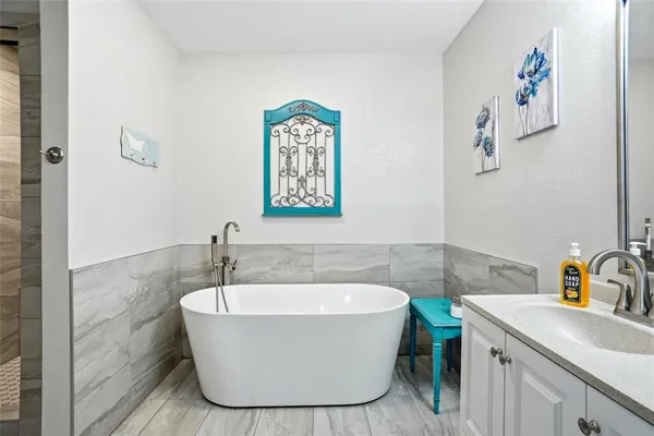 a bathroom with a bathtub and sink