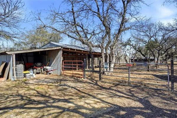 a view of a house with a patio and a yard