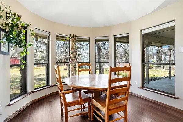 a view of a dining room with furniture wooden floor and a potted plant