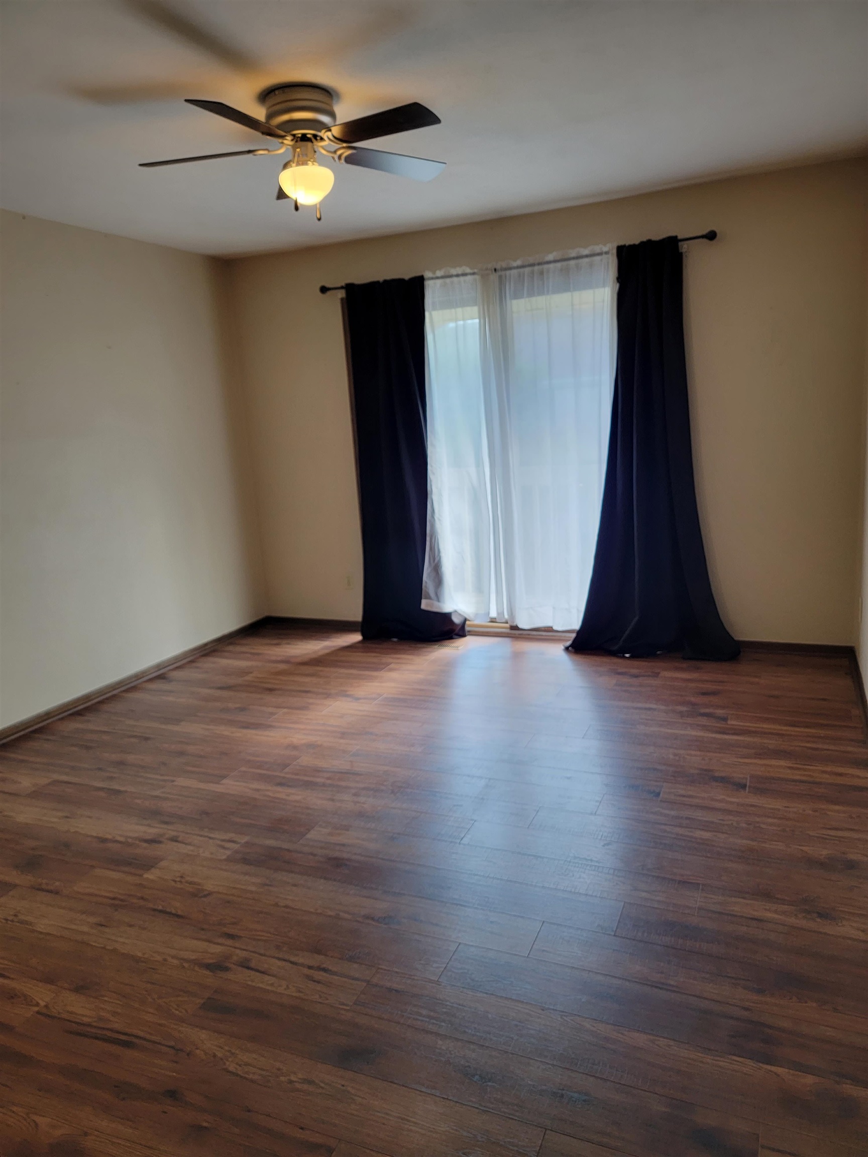 4685 High Point Drive Rockford, IL 61114 - Photo 11 of 20 a view of an empty room with wooden floor and a ceiling fan