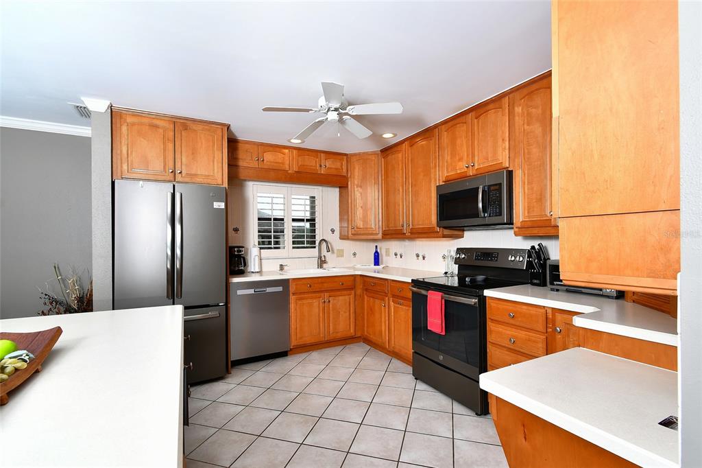 1590 Islamorada Boulevard, Unit 84C Punta Gorda, FL 33955 - Photo 12 of 38 a kitchen with stainless steel appliances granite countertop a sink stove and refrigerator
