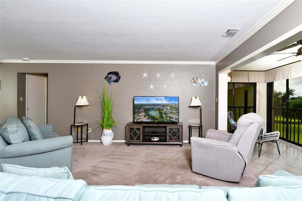 1590 Islamorada Boulevard, Unit 84C Punta Gorda, FL 33955 - Photo 19 of 38 a living room with furniture and a flat screen tv