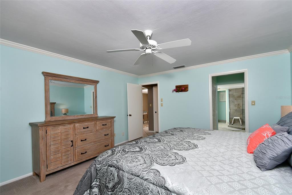 1590 Islamorada Boulevard, Unit 84C Punta Gorda, FL 33955 - Photo 24 of 38 a bedroom with a bed and a dresser