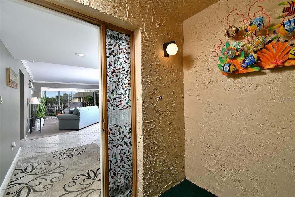 1590 Islamorada Boulevard, Unit 84C Punta Gorda, FL 33955 - Photo 8 of 38 a view of a hallway with wooden floor and a potted plant