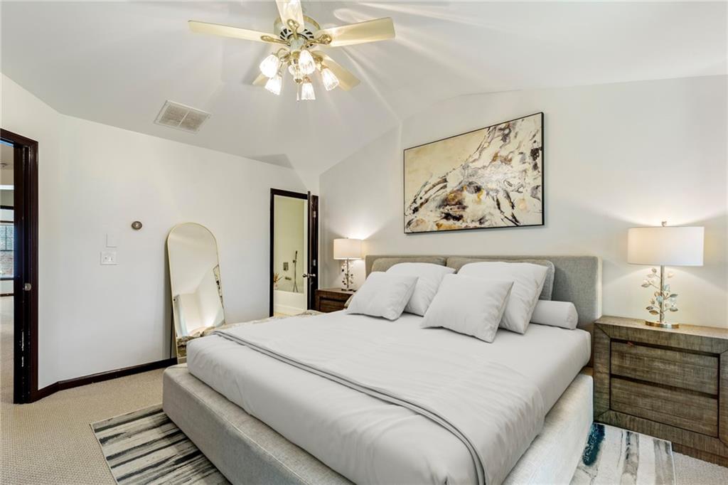 4430 Cedar Bridge Walk Suwanee, GA 30024 - Photo 19 of 29 a bedroom with a bed and a chandelier