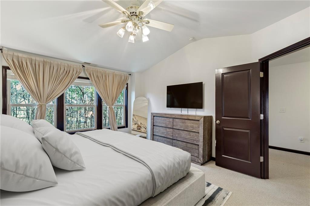4430 Cedar Bridge Walk Suwanee, GA 30024 - Photo 20 of 29 a bedroom with a bed and a flat screen tv
