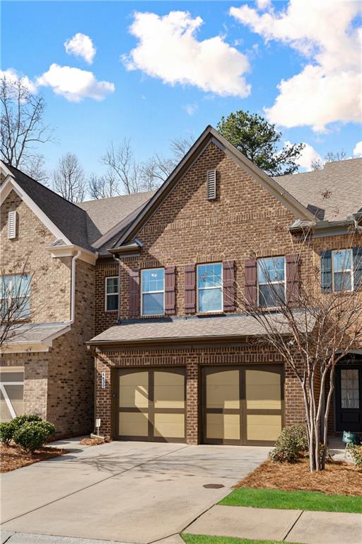 4430 Cedar Bridge Walk Suwanee, GA 30024 - Photo 2 of 29 a front view of a house with a yard