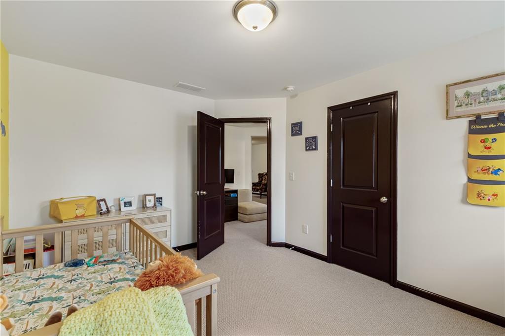 4430 Cedar Bridge Walk Suwanee, GA 30024 - Photo 22 of 29 a bedroom with a bed and a walk in closet