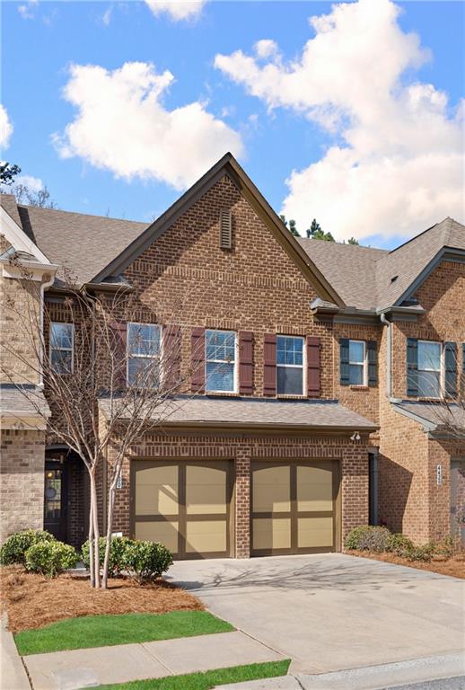 4430 Cedar Bridge Walk Suwanee, GA 30024 - Photo 3 of 29 a front view of a house with a garden