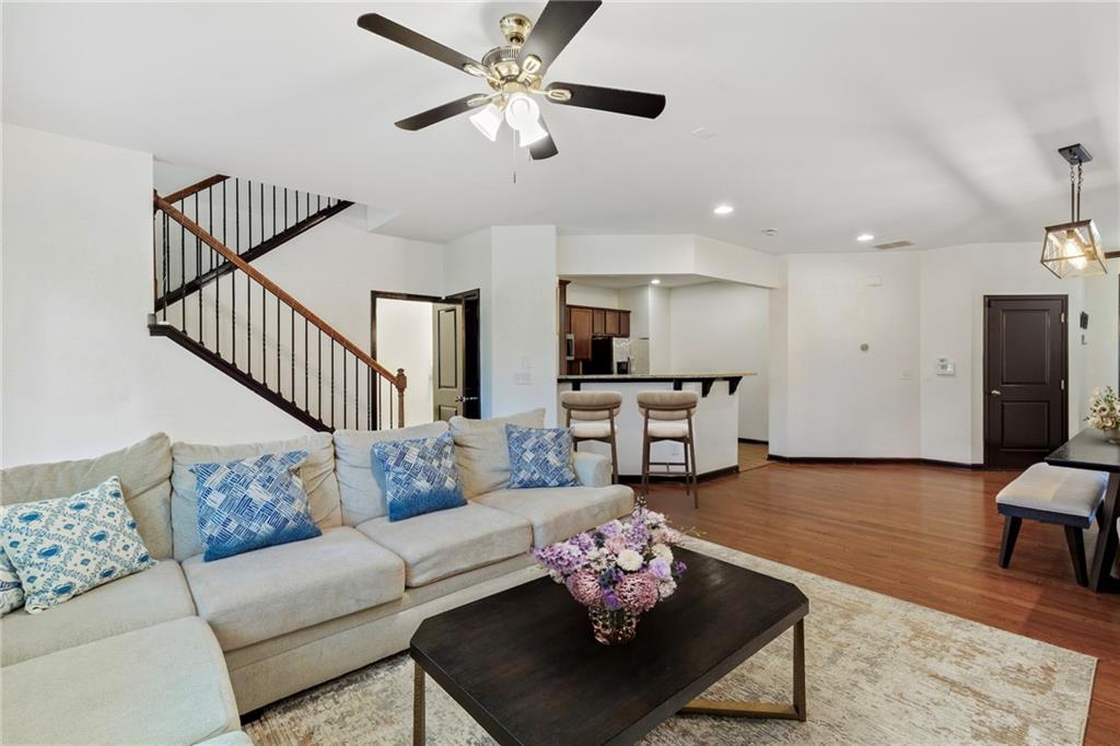 4430 Cedar Bridge Walk Suwanee, GA 30024 - Photo 8 of 29 a living room with furniture kitchen view and a chandelier