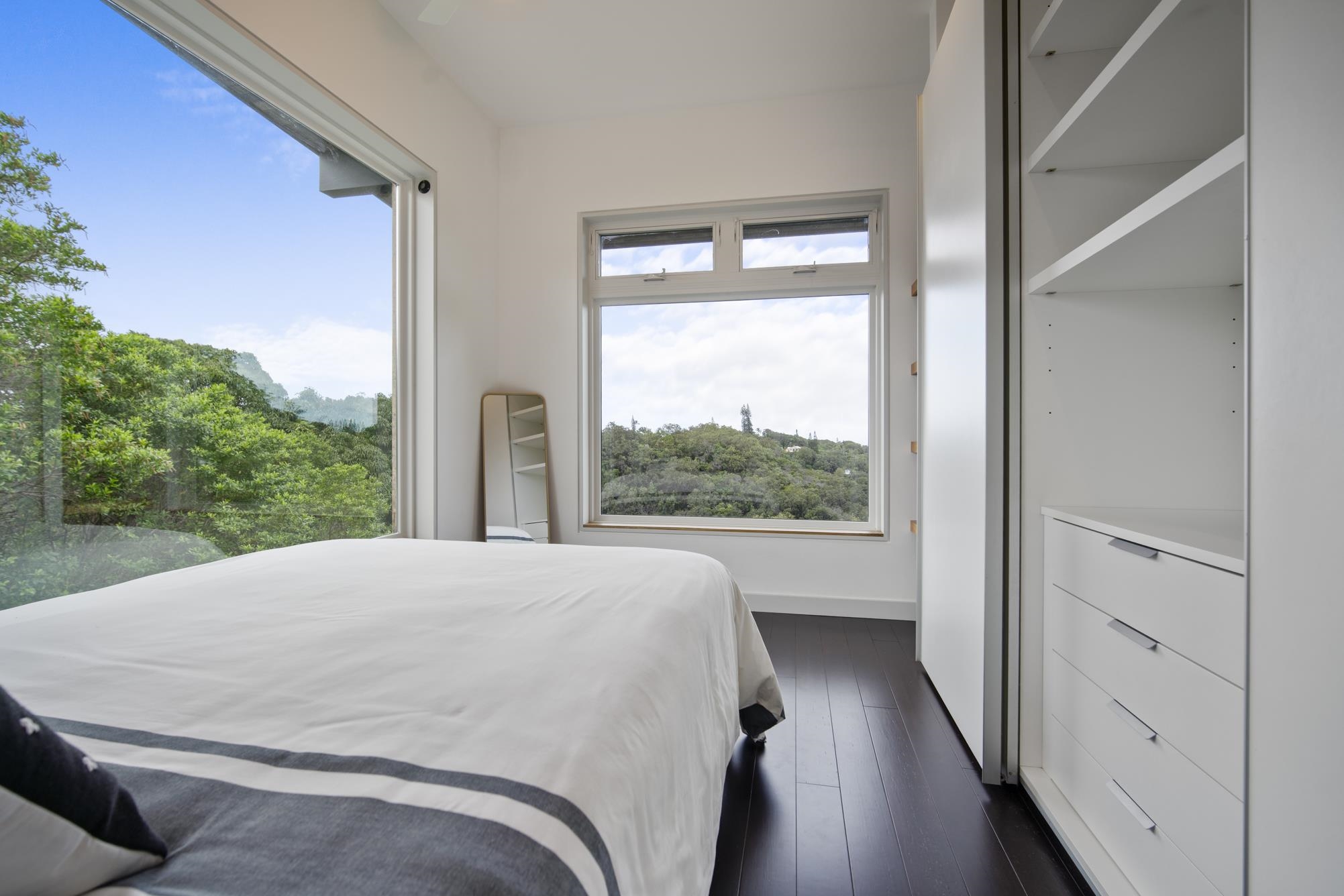 3127 Ua Noe Place, Unit B Haiku, HI 96708 - Photo 15 of 50 a view of a bedroom with wooden floor and windows
