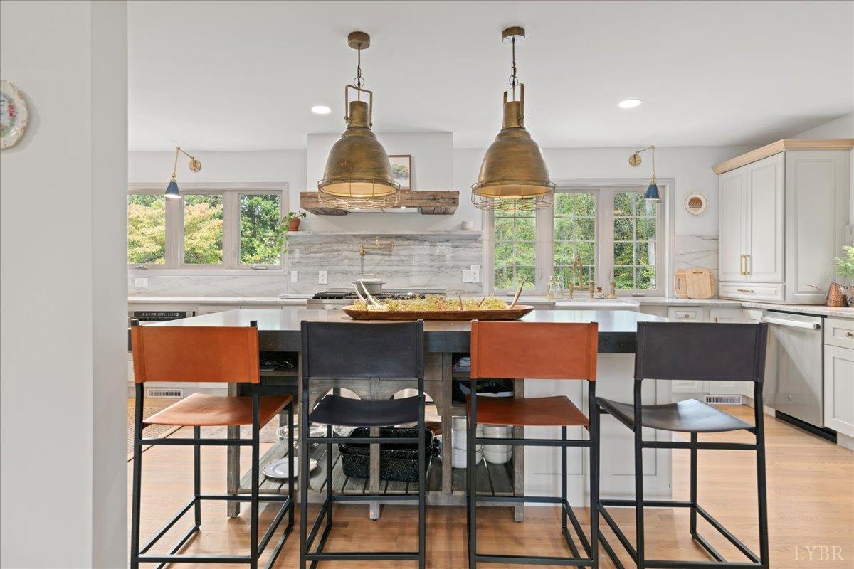 181 Mobley Mountain Road Amherst, VA 24521 - Photo 23 of 98 a kitchen with stainless steel appliances granite countertop a table chairs and a wooden floor