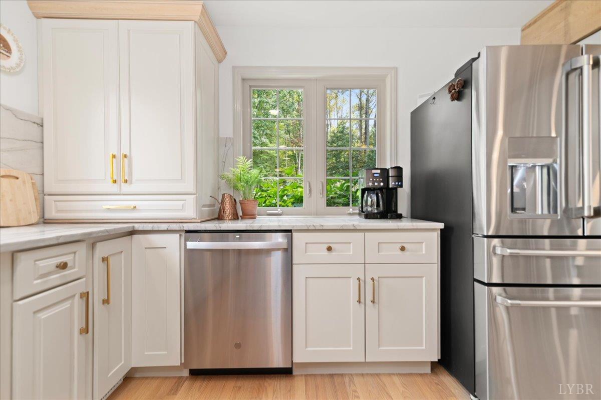 181 Mobley Mountain Road Amherst, VA 24521 - Photo 27 of 98 a kitchen with white cabinets and white stainless steel appliances