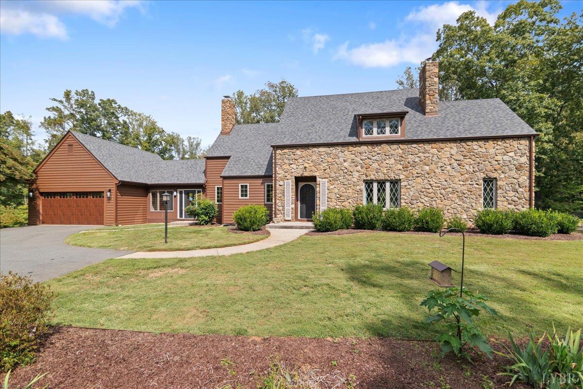 181 Mobley Mountain Road Amherst, VA 24521 - Photo 3 of 98 a front view of a house with a yard and garage