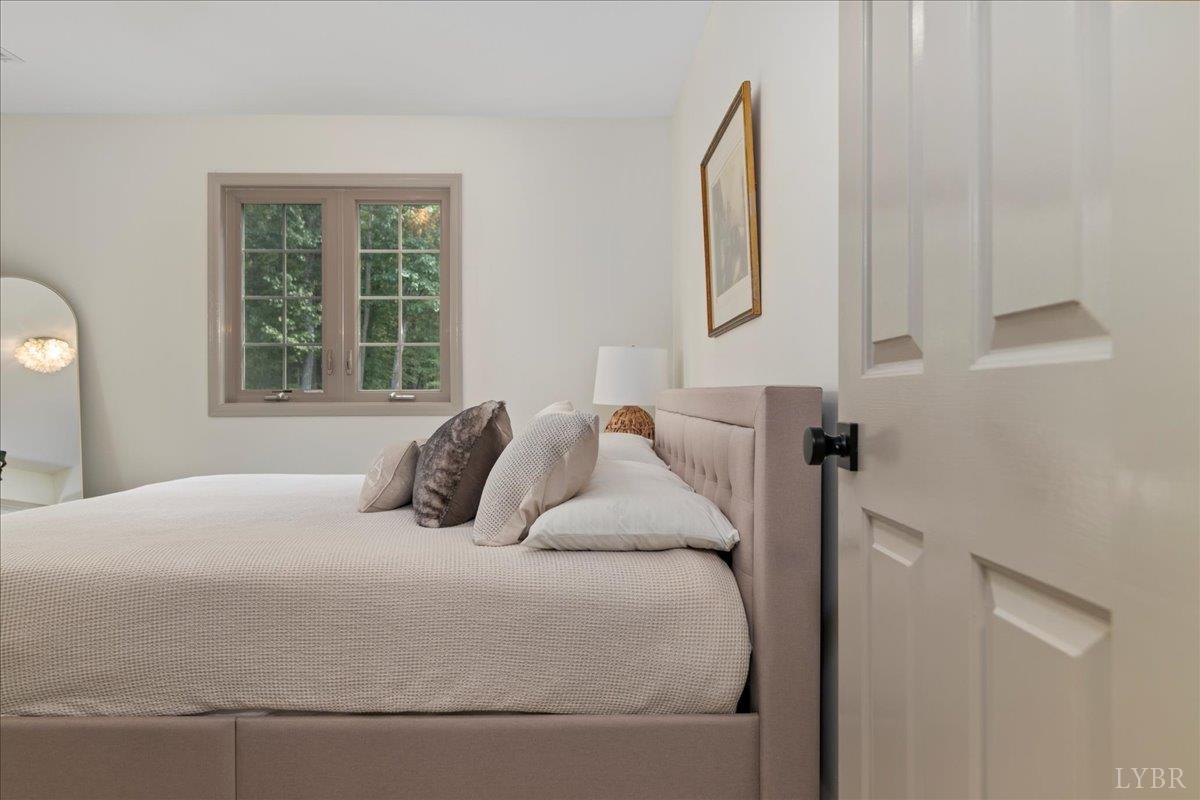 181 Mobley Mountain Road Amherst, VA 24521 - Photo 66 of 98 a bedroom with a large bed and a window