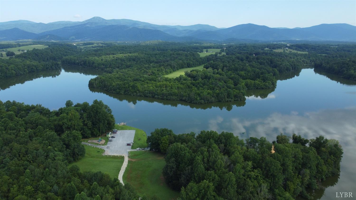 181 Mobley Mountain Road Amherst, VA 24521 - Photo 97 of 98 an aerial view of green landscape with trees houses and mountain view