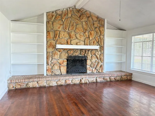 a view of a fireplace with wooden floor
