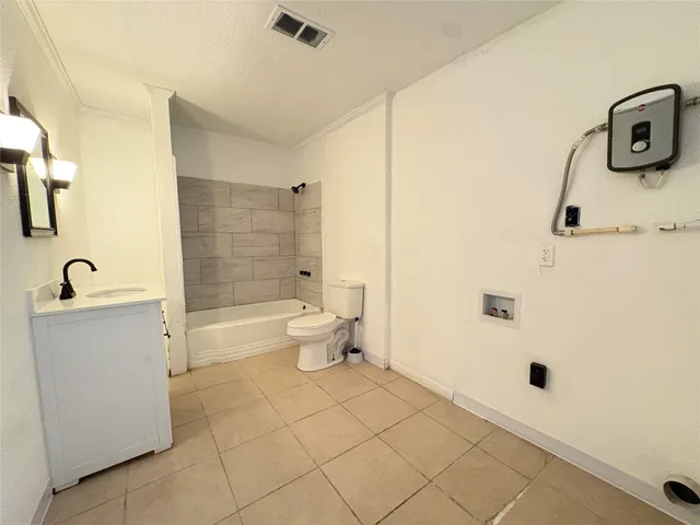 a bathroom with a toilet a sink and bathtub