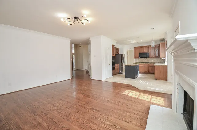 a view of a house with a backyard and a tree