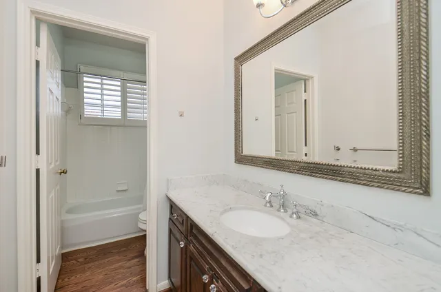 a view of a kitchen with a sink a refrigerator and a stove top oven