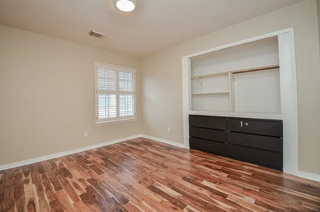 a bathroom with a granite countertop sink and a bathtub