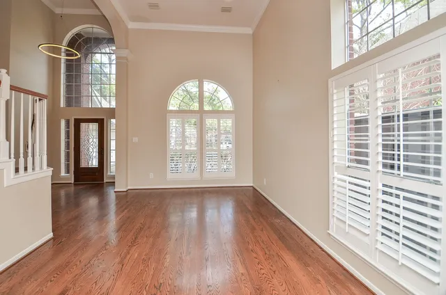 a view of entryway and hall with wooden floor
