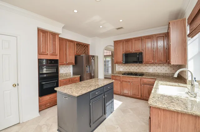 a kitchen with stainless steel appliances granite countertop a stove and a sink