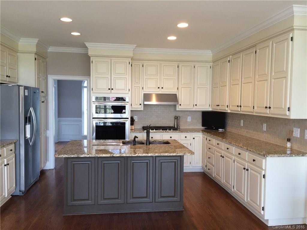 4732 Binfords Ridge Road Charlotte, NC 28226 - Photo 4 of 13 a kitchen with kitchen island granite countertop a sink stove and refrigerator